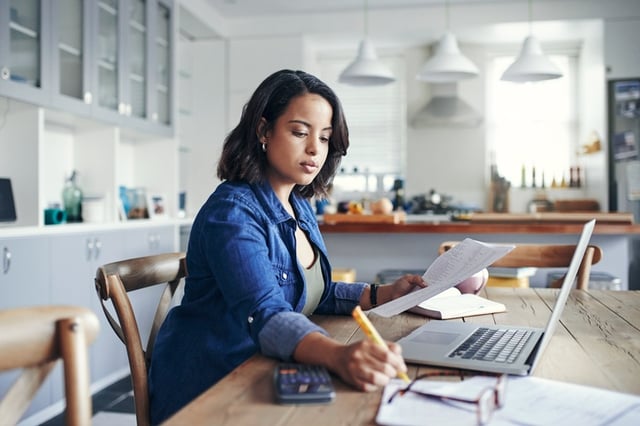 Woman creating budget on computer